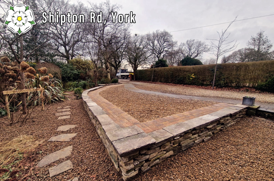 Raised gravel driveway with dry-stone walling